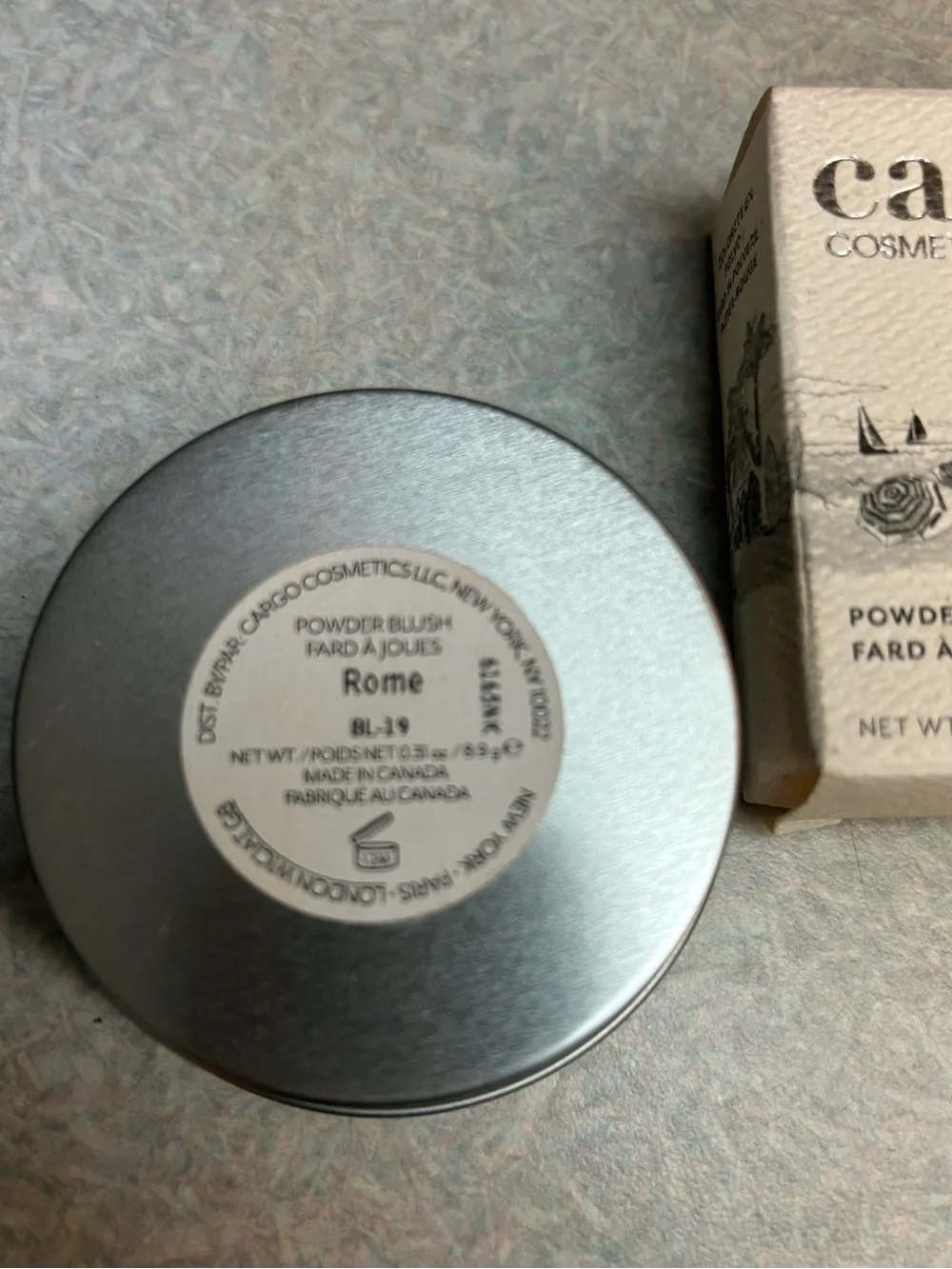 Cargo Cosmetics Powder Blush in Rome (peachy coral in color).